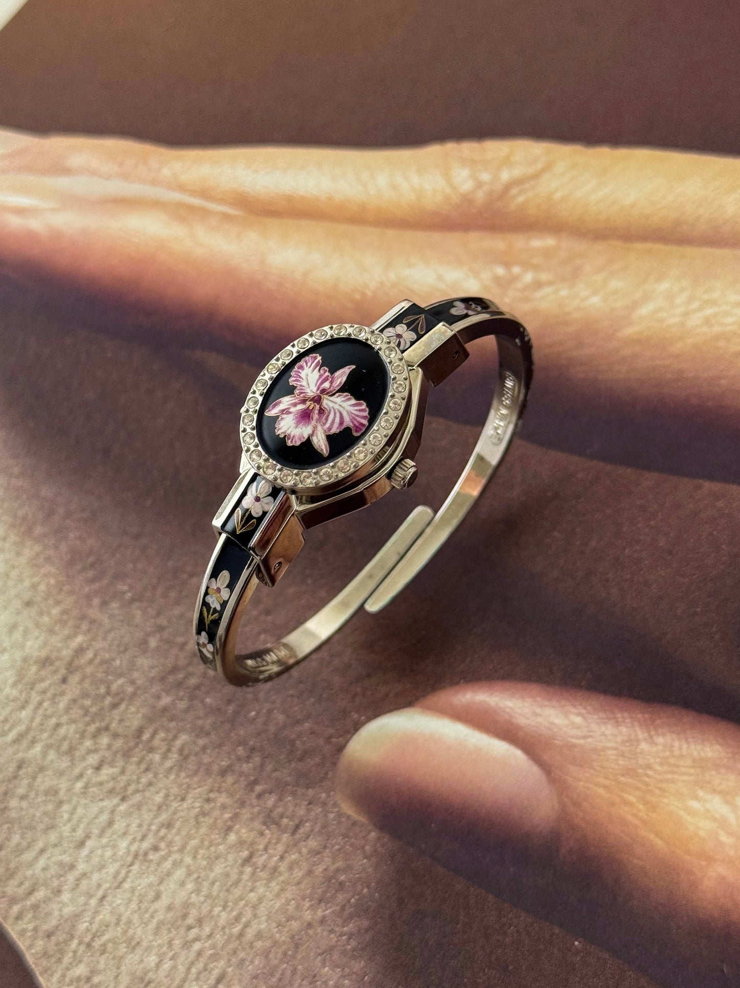 Vintage Silver Tone André Mouche Peekaboo Cuff Watch With a Black Enamel Purple Hibiscus Flower Design and Crystal Bezel