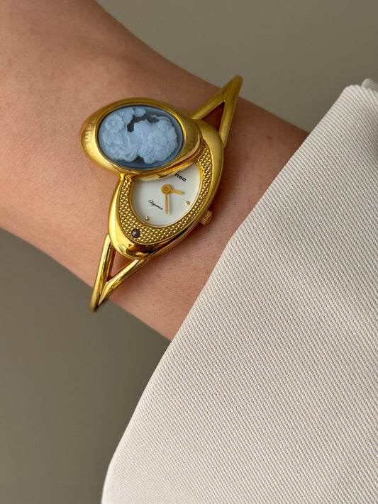 Rare Vintage Gold Tone Bangle Watch With A Blue Cameo Peekaboo Dial