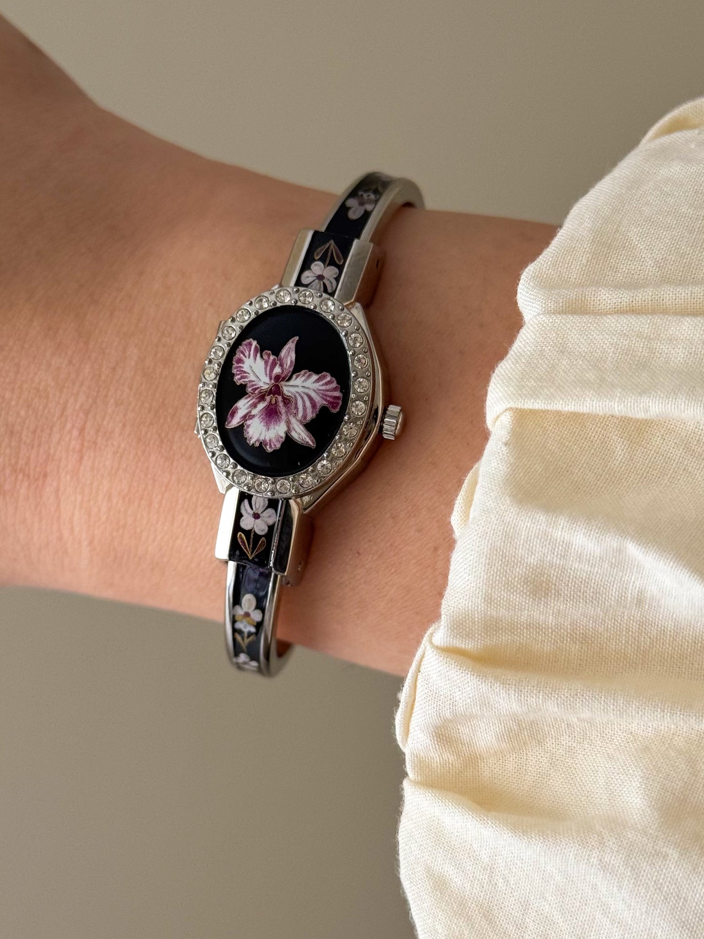 Vintage Silver Tone André Mouche Peekaboo Cuff Watch With a Black Enamel Purple Hibiscus Flower Design and Crystal Bezel
