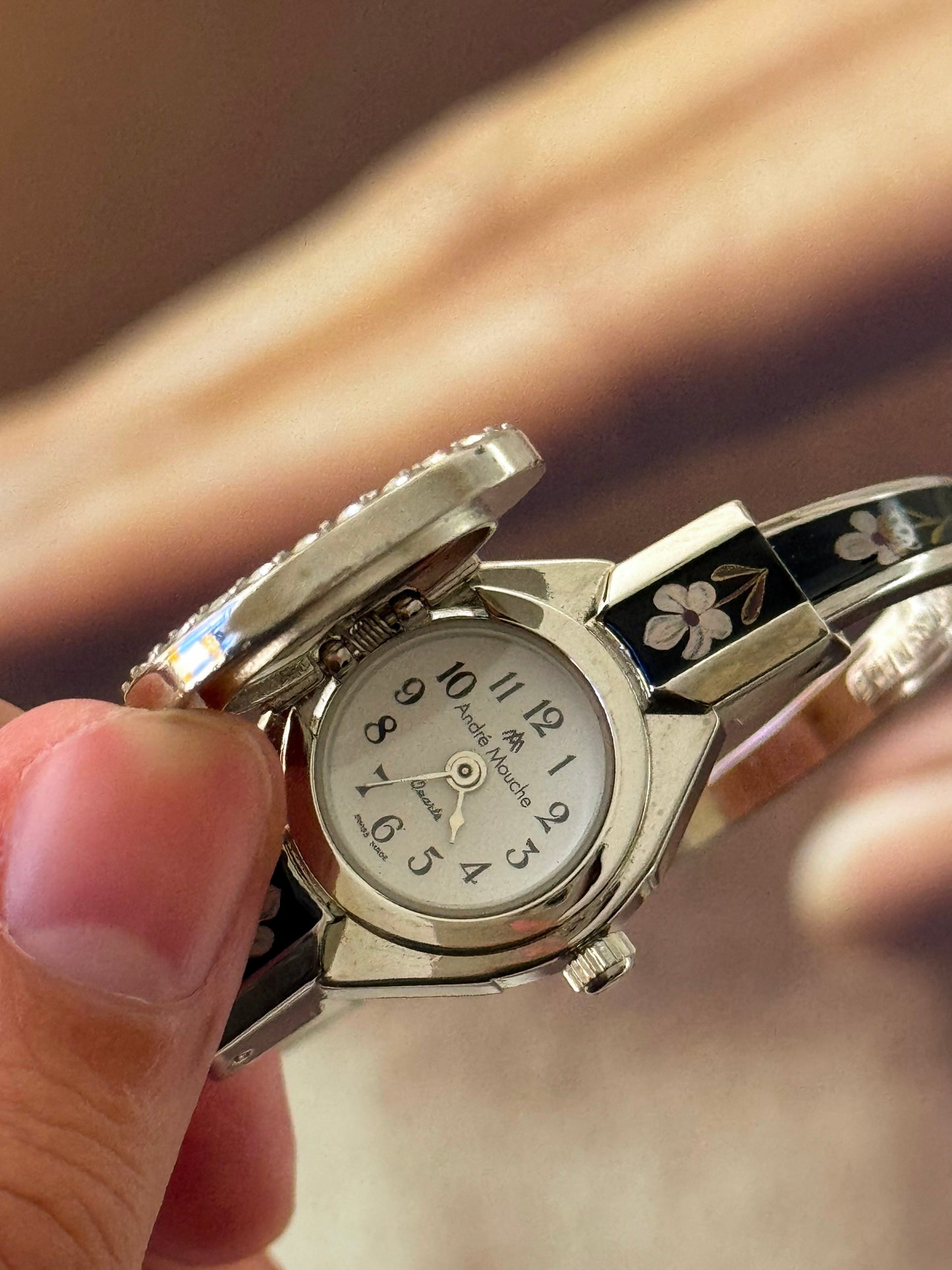 Vintage Silver Tone André Mouche Peekaboo Cuff Watch With a Black Enamel Purple Hibiscus Flower Design and Crystal Bezel
