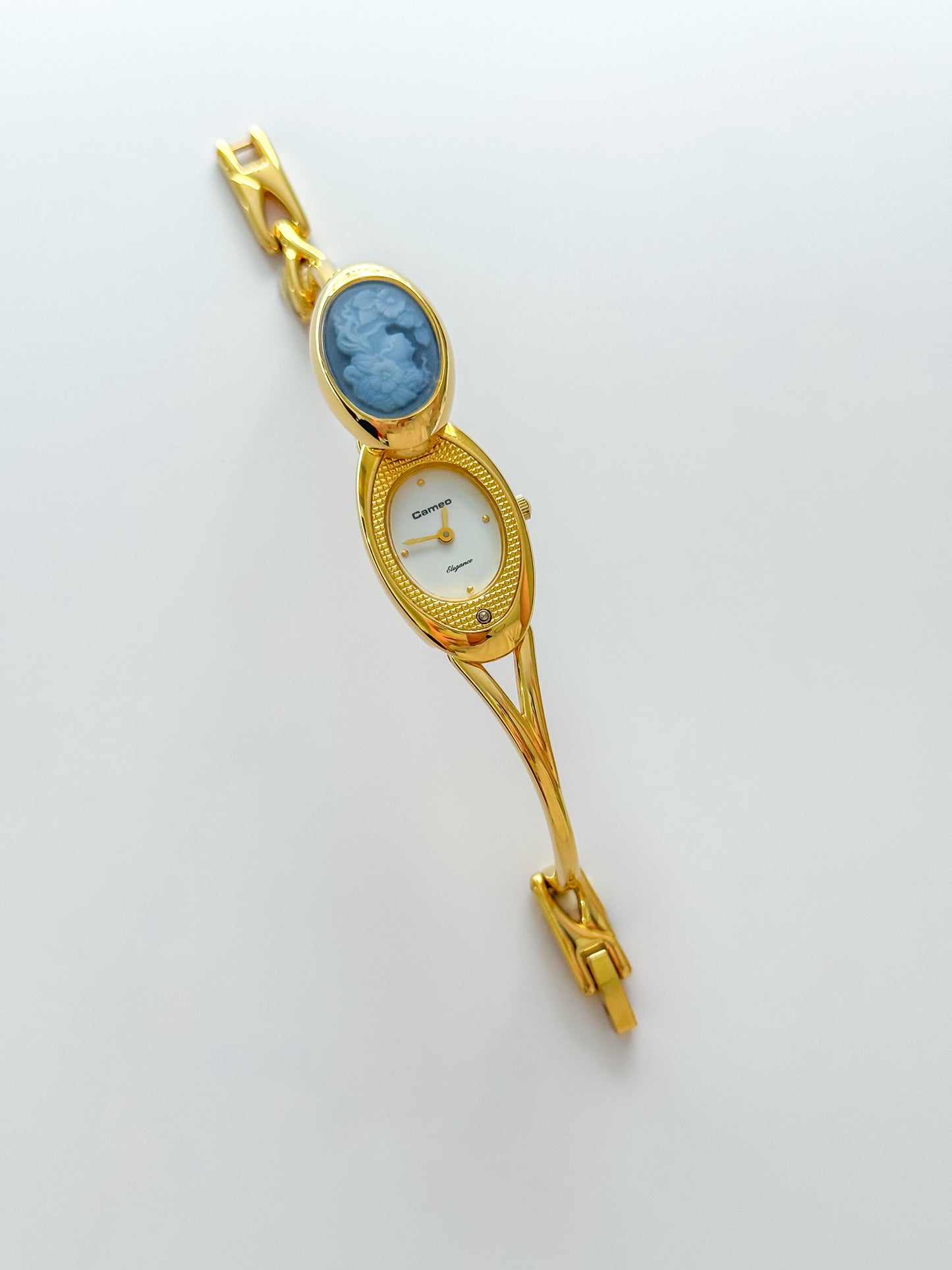 Rare Vintage Gold Tone Bangle Watch With A Blue Cameo Peekaboo Dial