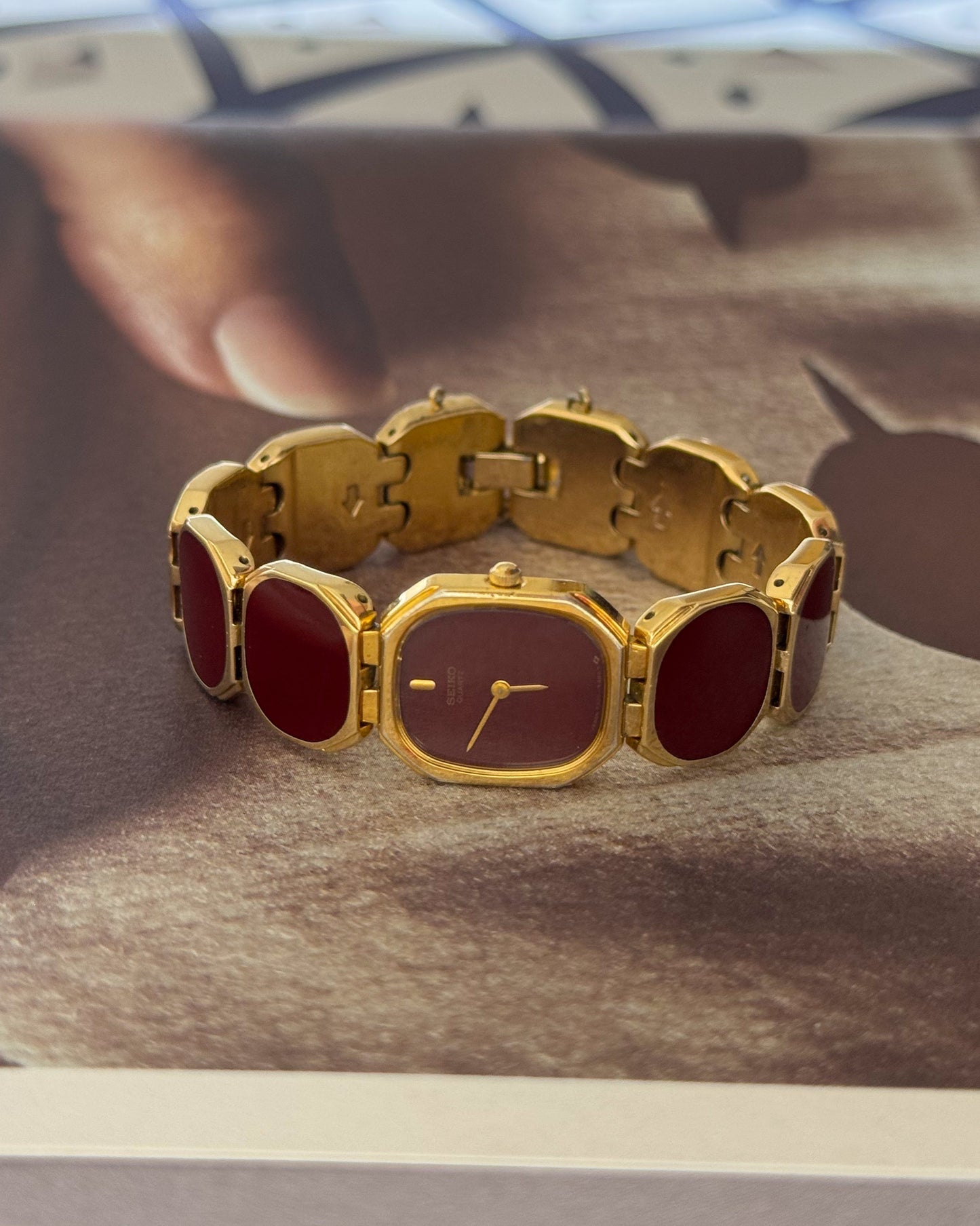 Extremely Rare and Gorgeous Seiko Watch With Deep Burgundy Tone Enamel and Gold Accents.
