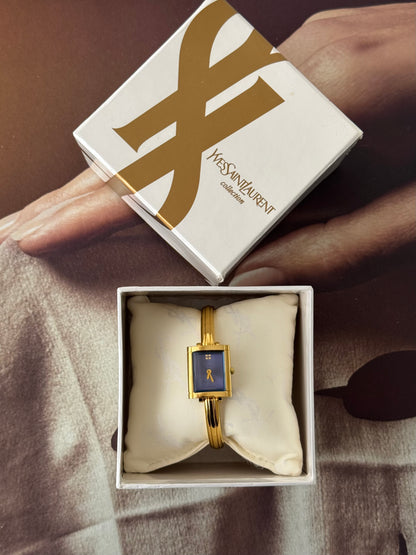 Vintage 90s Gold Tone Yves Saint Laurent (YSL) Bangle Watch With Blue Square Dial